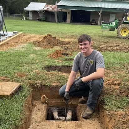 Hinson technician inspecting a septic access port